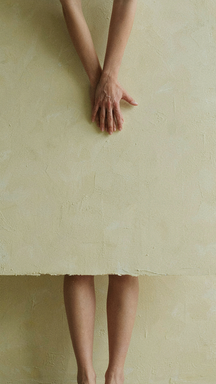 Sunlight softly illuminating the textured surface of a matte, cream-colored lime-washed wall.