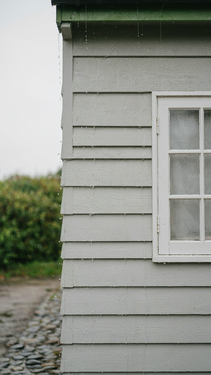 Durable fiber cement board siding on a cottage sheds water easily.