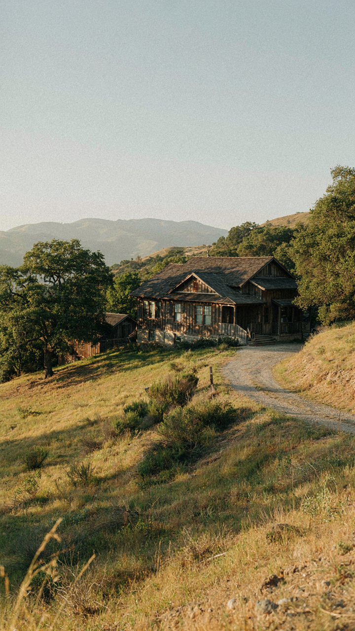A ranch farmhouse built into a hillside, with deep overhangs for sun protection.