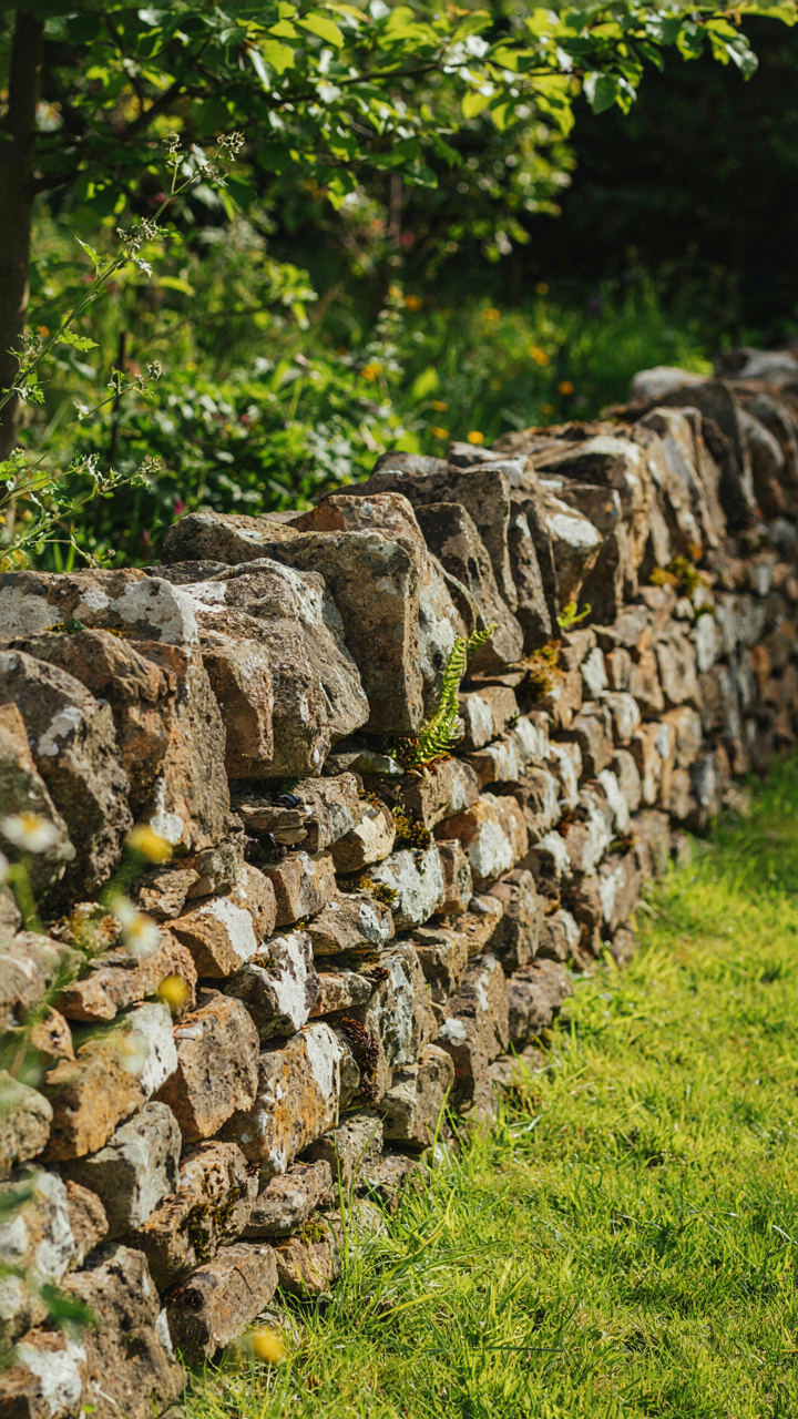 Stone foundation made of loose fieldstones, with visible gaps.