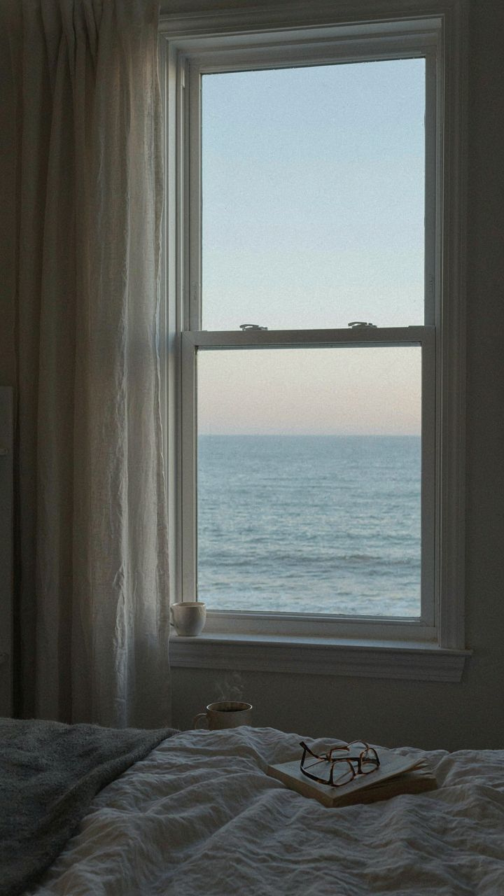 An east-facing bedroom window shows the soft blue light of early morning.