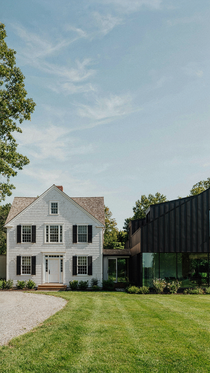An old colonial farmhouse with a visible addition and stepped roofline.