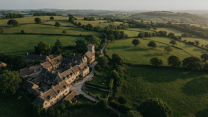 Aerial view of a picturesque Cotswold village with honey stone cottages.