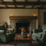 A cozy living room featuring prominent cottage ceiling beams and a warm fireplace.