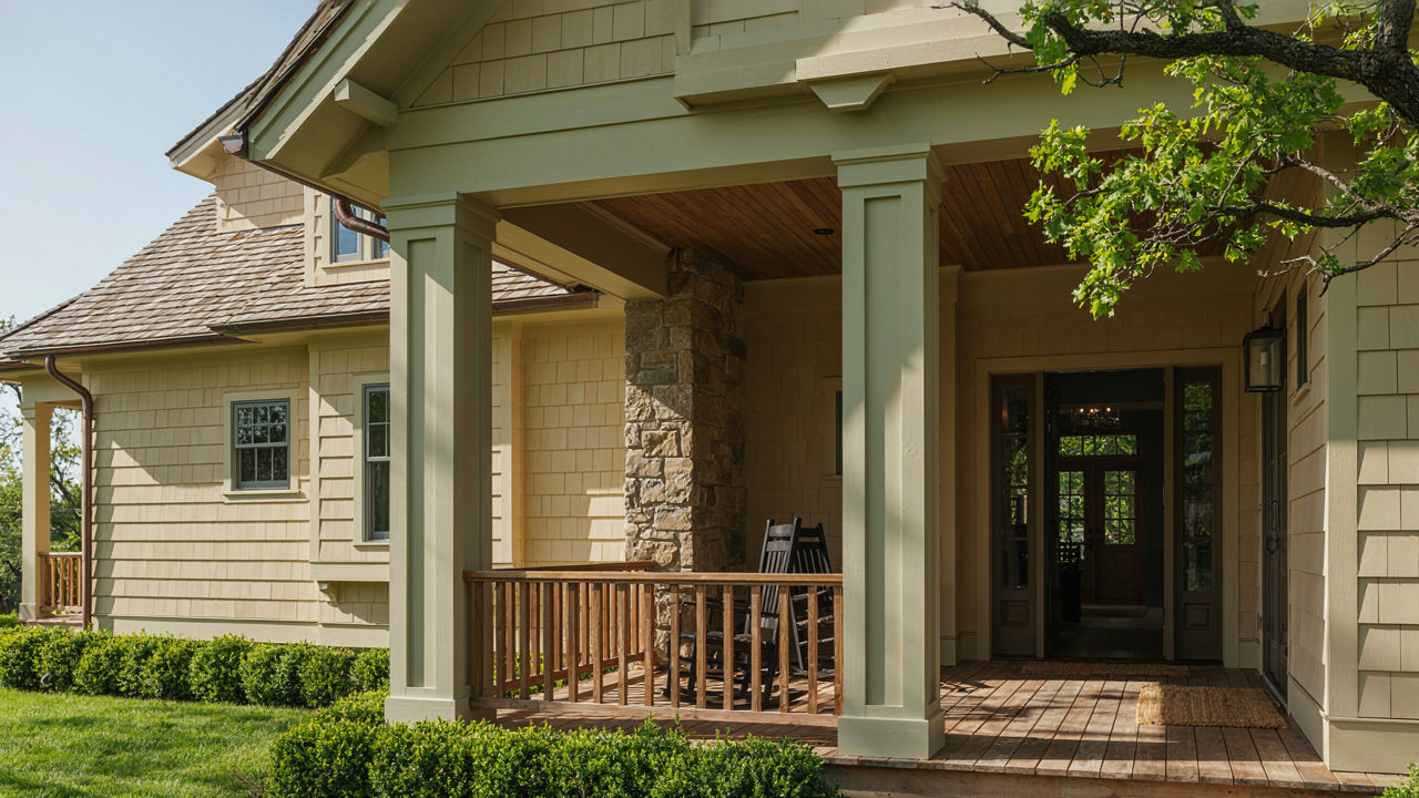 Grand craftsman porch with tapered columns on a home exterior, showcasing elegant design.
