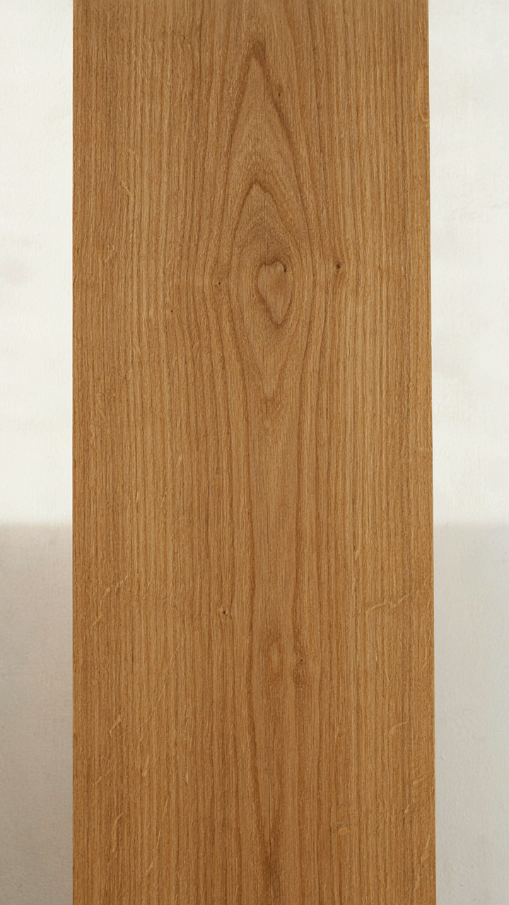 A section of smoothly oiled quarter-sawn oak board, showing natural grain.