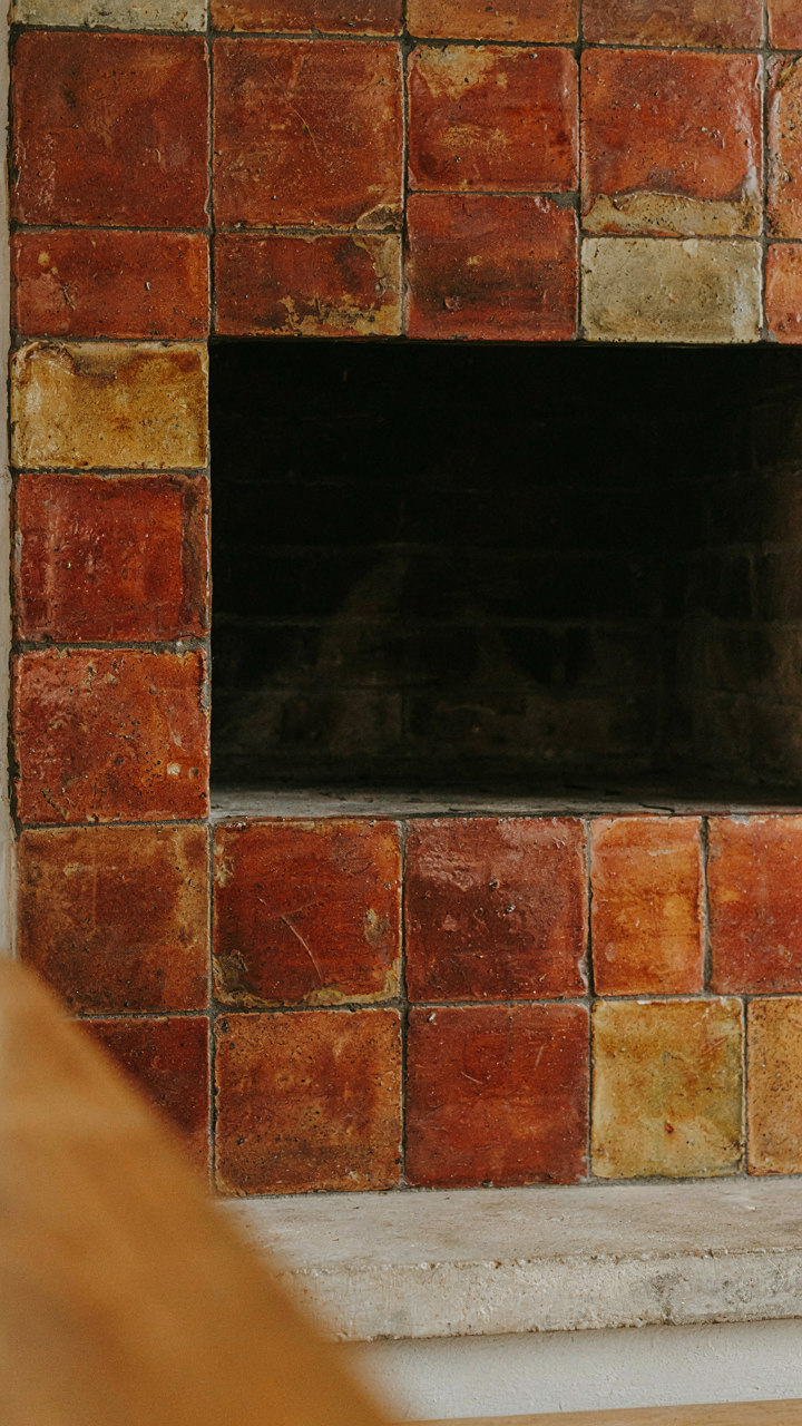 Close-up of irregular clinker tiles with earth tones and geometric patterns.