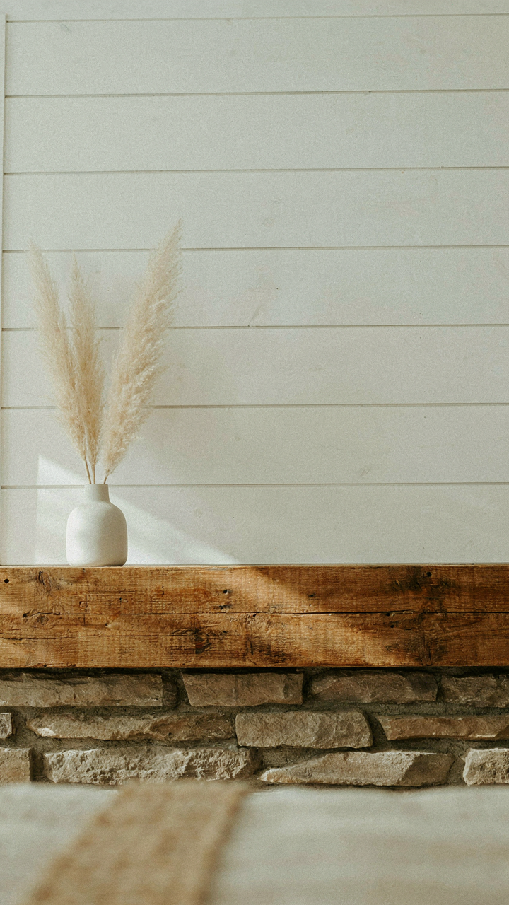 A shiplap fireplace with a thick wood mantel and stone hearth.
