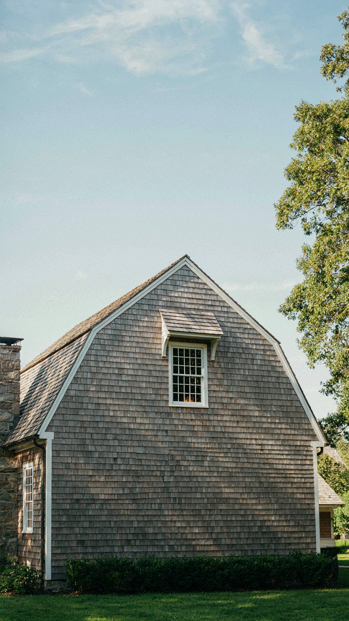 A well-placed dormer window on a gambrel roof of a Dutch Colonial home.