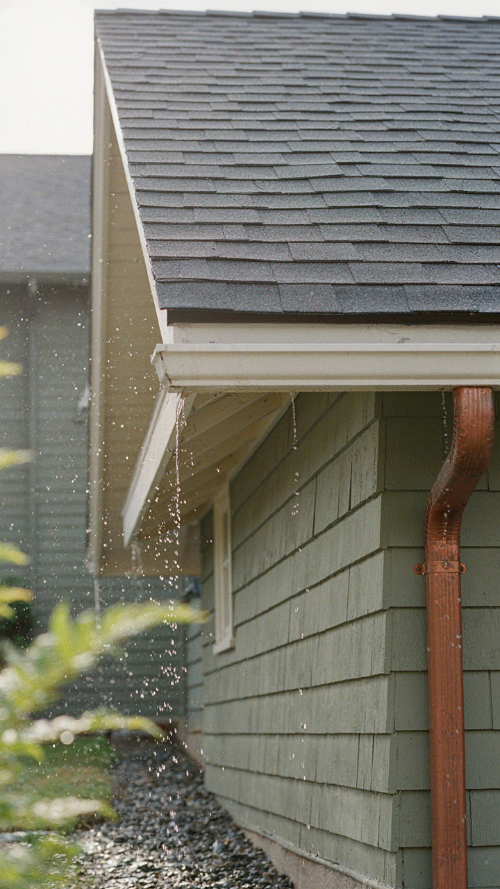 A wide roof overhang directing rainwater away from a house's foundation.