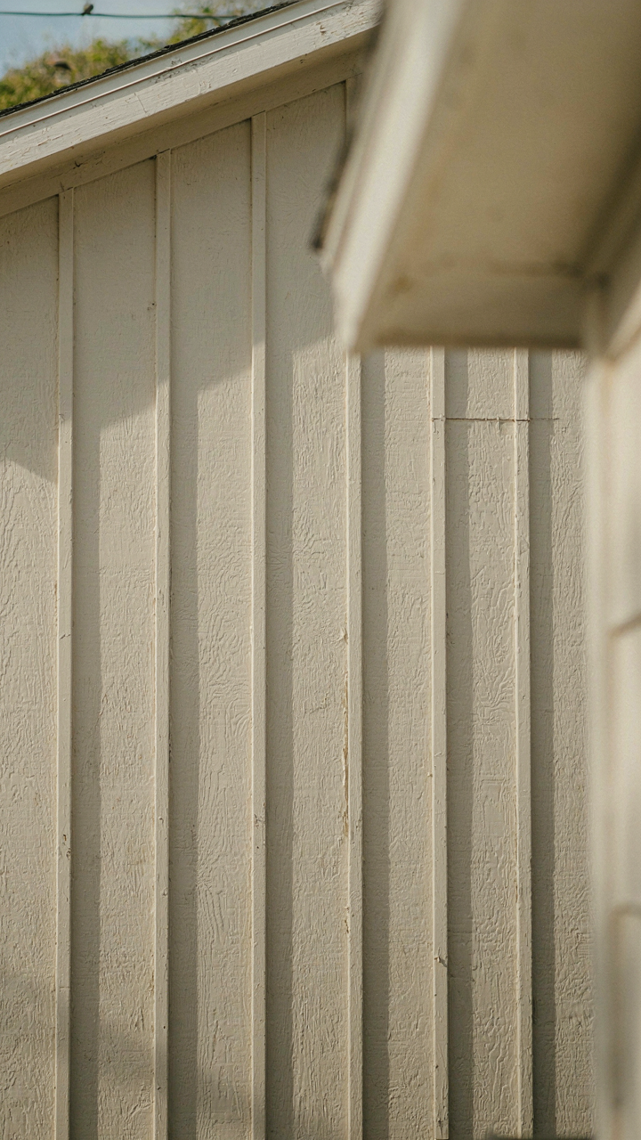 Close-up of durable fiber cement board siding on a one story farmhouse.