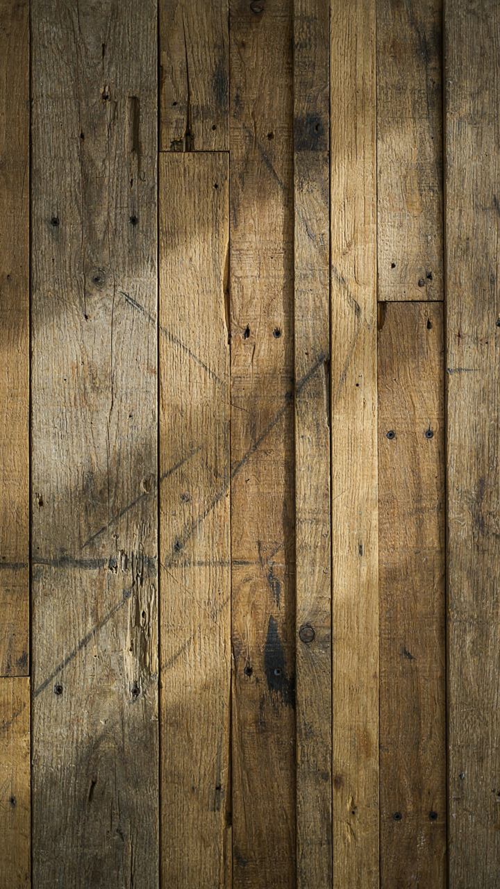 A close-up shows deep scratches and color variations on a reclaimed wood headboard.