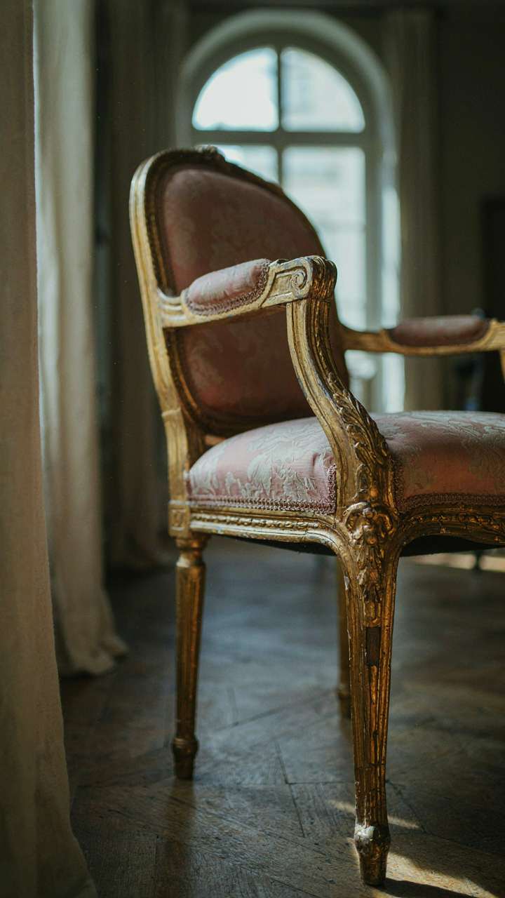 A close-up of an antique Louis XVI chair with visible repair marks.