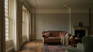 Elegant living room in a Georgian house with antique furniture and tall windows.