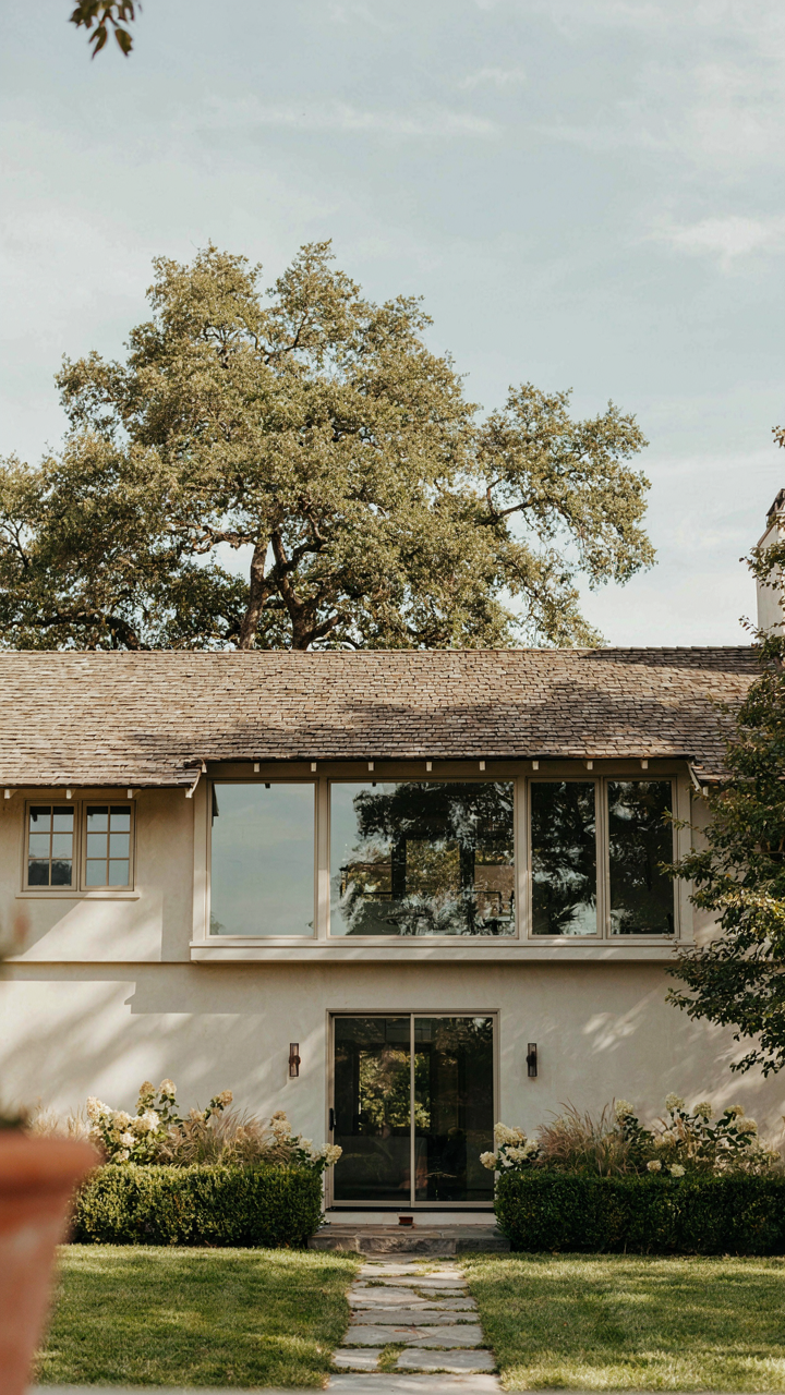 A ranch house addition extends towards a garden at the back.