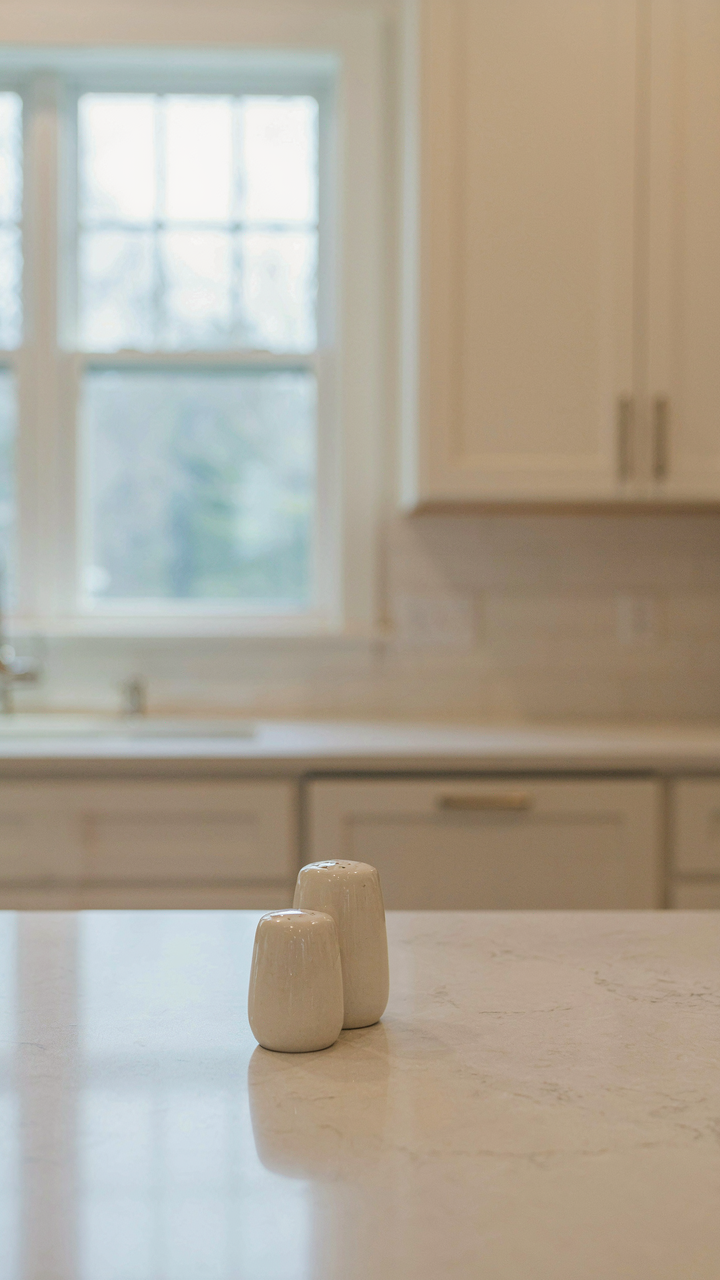 A clean kitchen counter with only salt and pepper shakers.