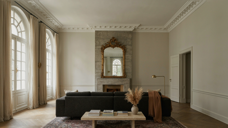 A modern Victorian living room with a blend of old and new decor.