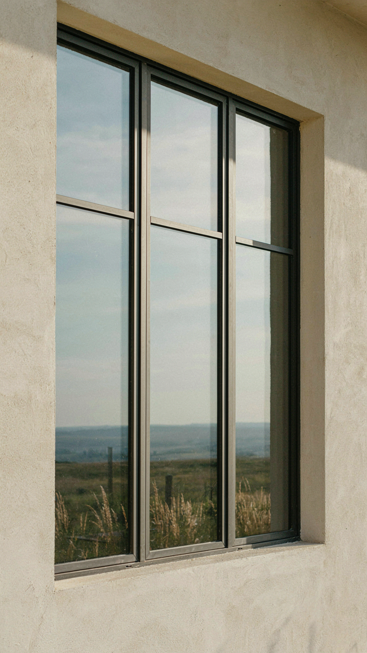 Modern prairie style windows with triple-glazed panes and aluminum frames in an insulated wall.