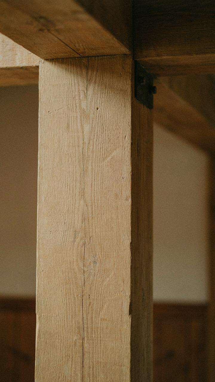 A close-up of a sturdy, exposed quarter-sawn white oak beam.