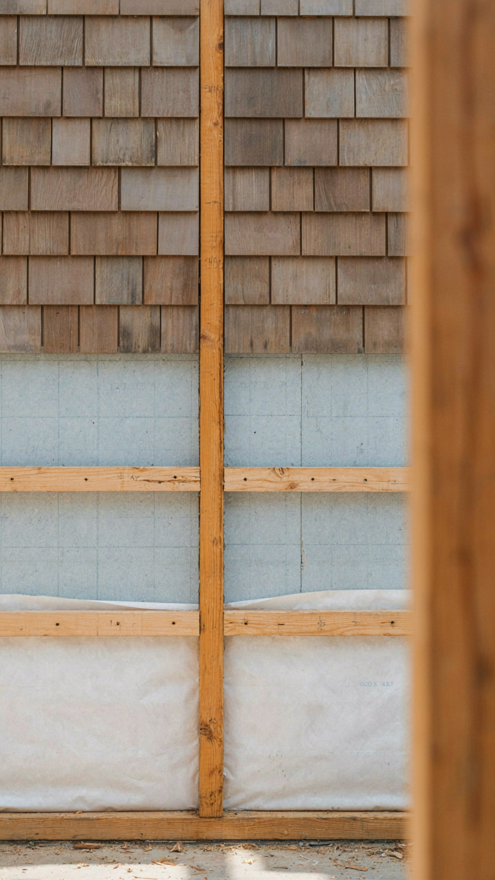 A cross-section of a modern farmhouse wall shows layers of insulation and clapboard siding.