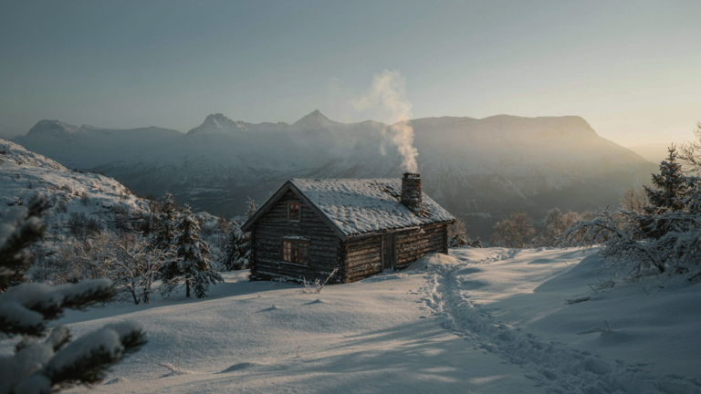 A rustic Norwegian cabin in a snowy mountain landscape with smoke from the chimney.
