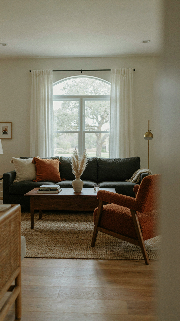 A ranch interior with a dark charcoal sofa as a visual anchor in the living room.