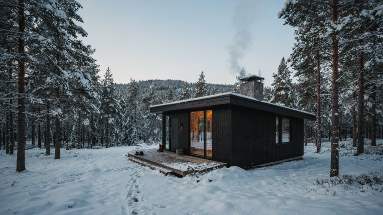 A modern scandinavian cabin in a snowy forest, steam rising from its chimney.