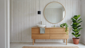 A clean scandinavian cottage bathroom with whitewashed wood walls and a sink.