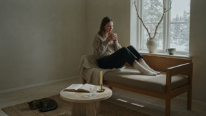 A warm and inviting scandinavian cottage interior with a large window and simple decor.