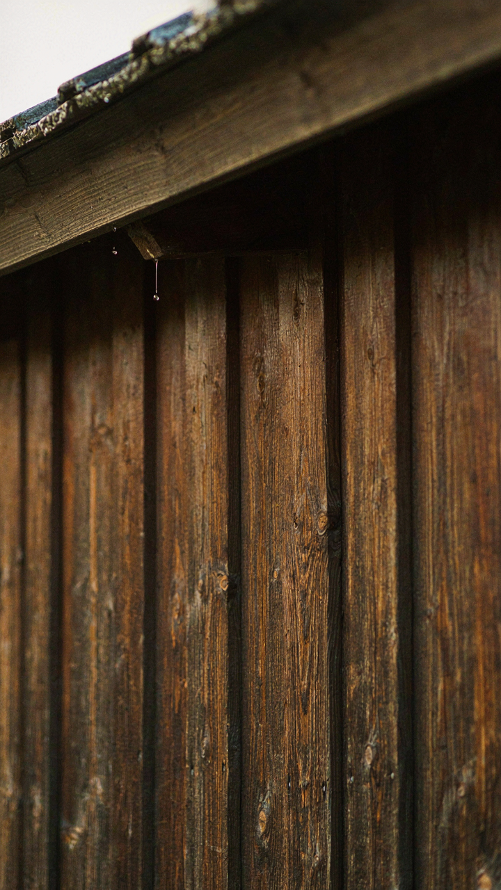 Overlapping wooden cladding on a scandinavian barn house exterior with a roof overhang.