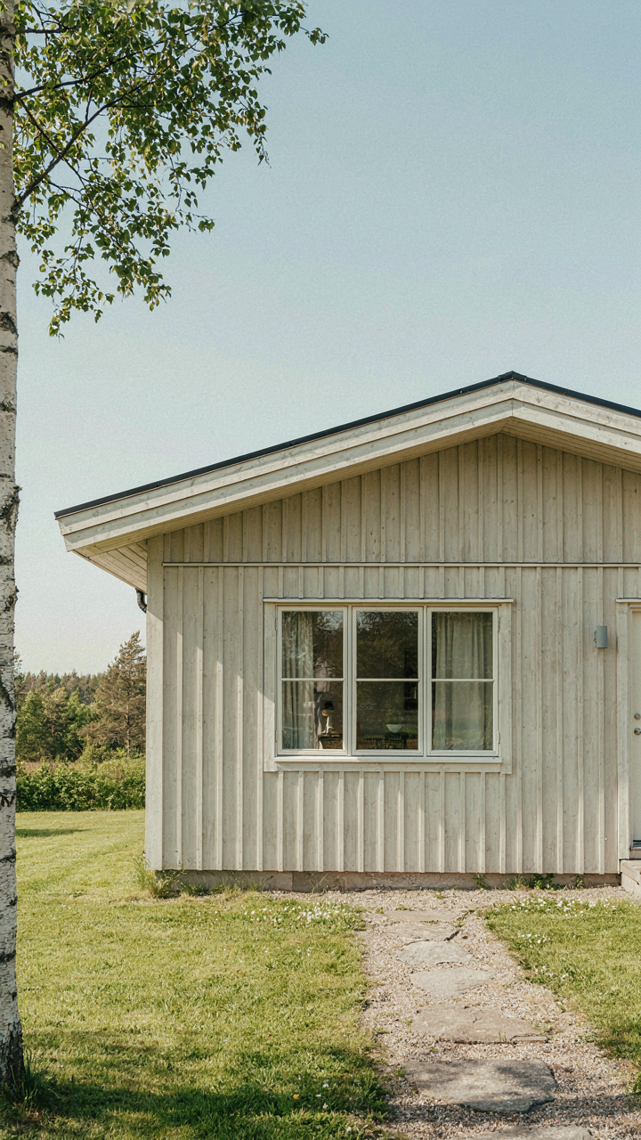 A scandinavian bungalow with a deep overhang casts shade below the window.