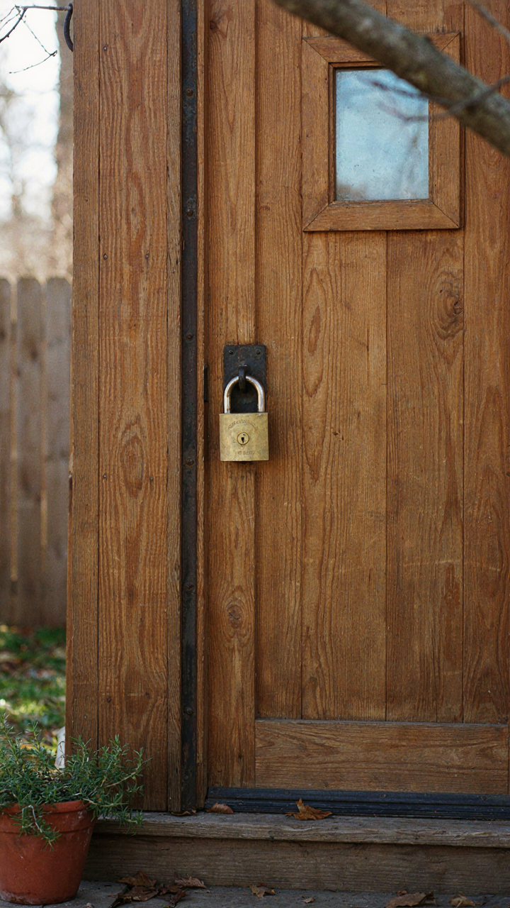 A heavy padlock secures the door of a she shed office.