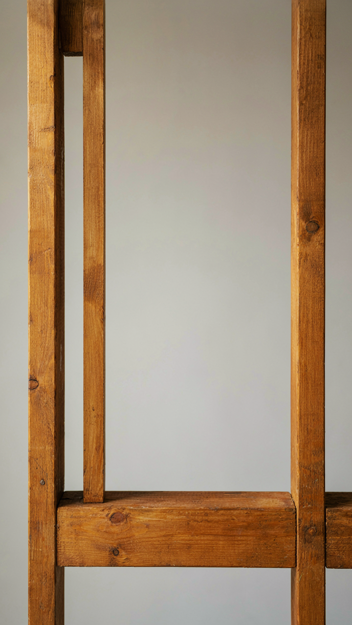A cross-section of a shed door frame with tapered posts and a thick bottom rail.
