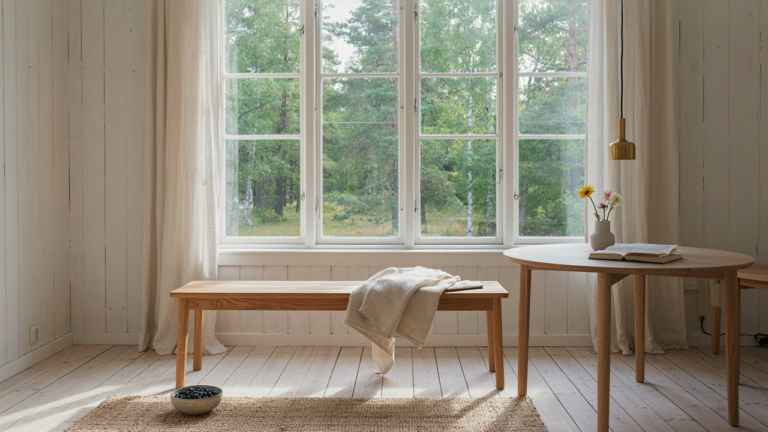 A bright, serene swedish summer house interior with white walls and natural light.