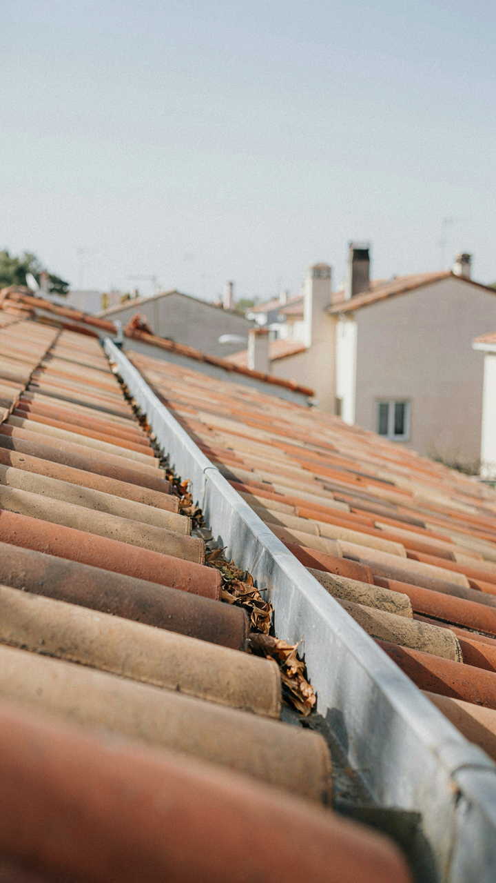 A long, continuous gutter on a low-pitched roof, gently sloping.
