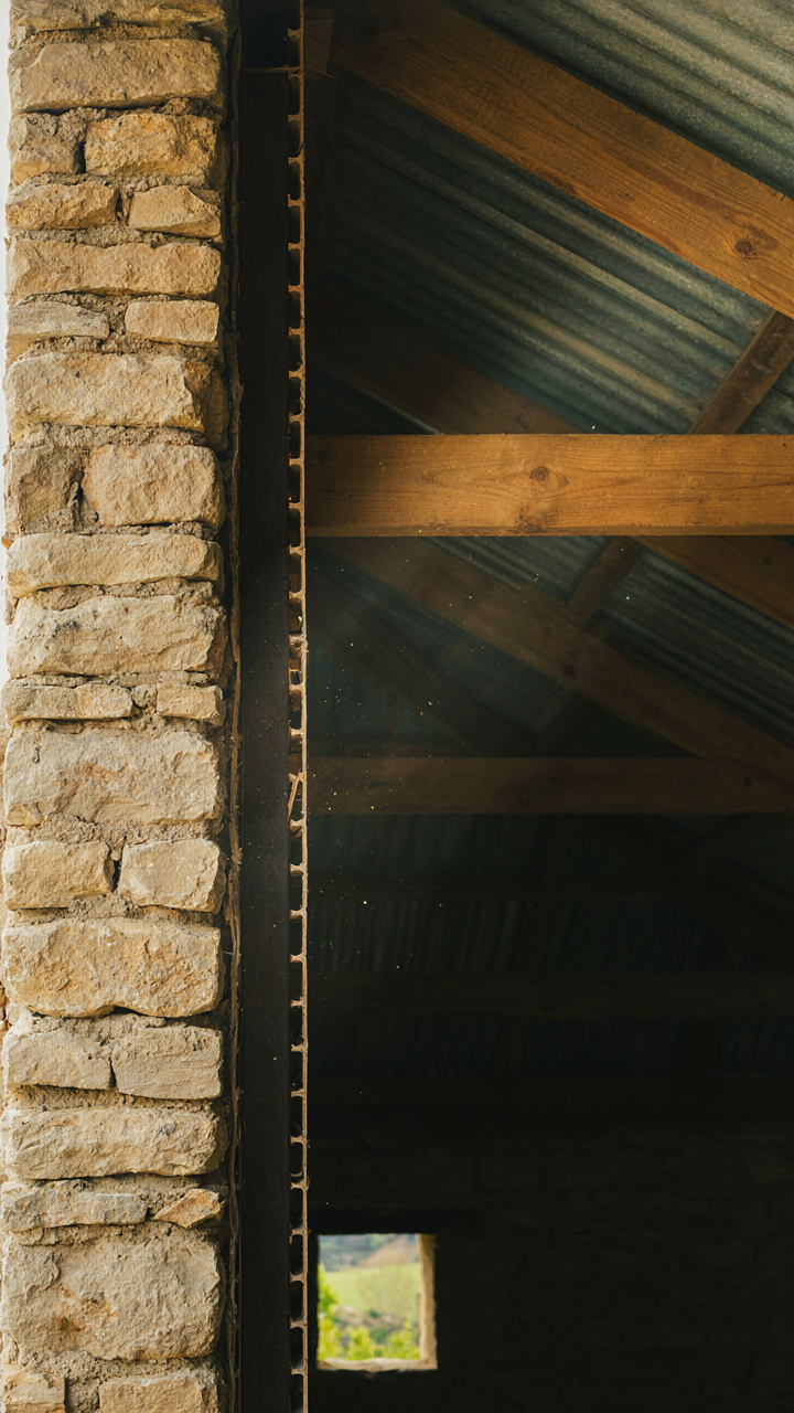A cutaway view of a hill country farmhouse wall and roof structure.