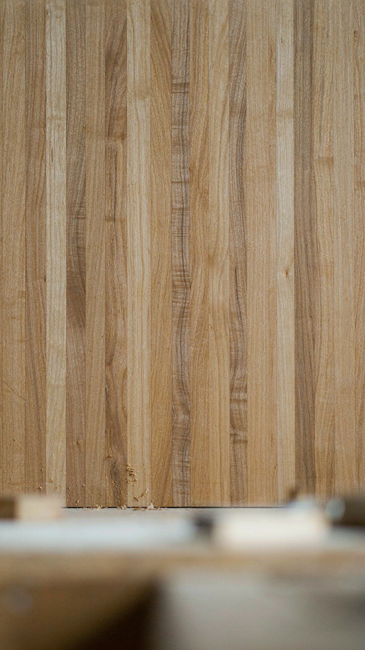 Close-up of a hand-planed quarter-sawn oak surface with visible medullary rays.