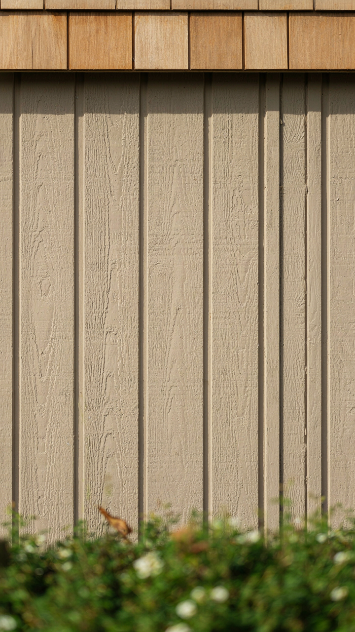 A close-up view of durable fiber cement siding on a modern building.