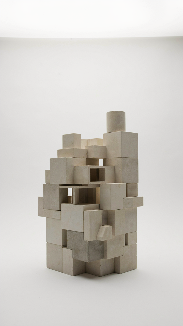 Abstract architectural model with irregular blocks and a small turret.
