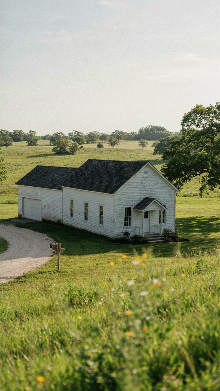 A farmhouse with an attached side garage forming an awkward L-shape.
