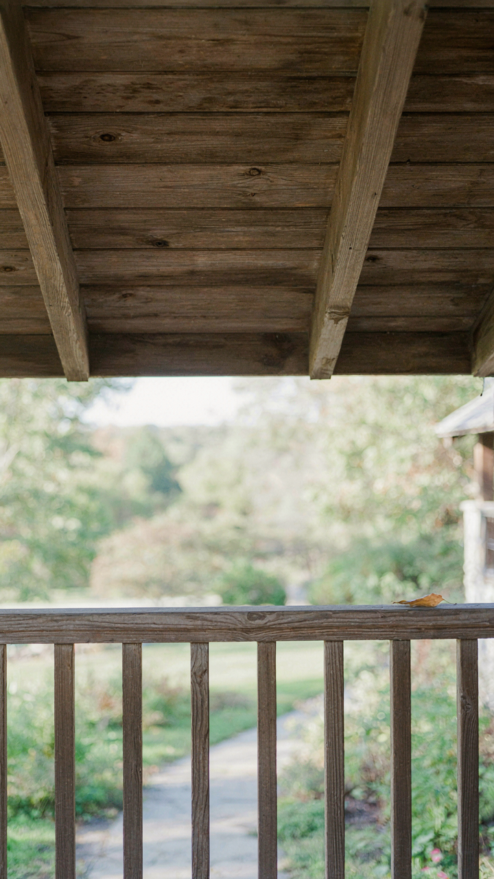 A cedar porch railing shows graceful weathering over time.