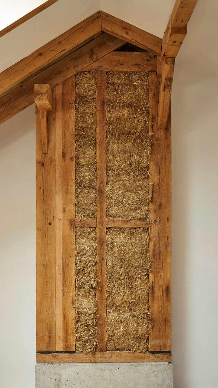 Cross-section of a thick timber wall showing layers of wood and insulation.
