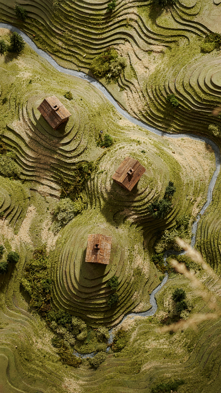 A topographic map with tiny cabin models illustrating strategic placement.