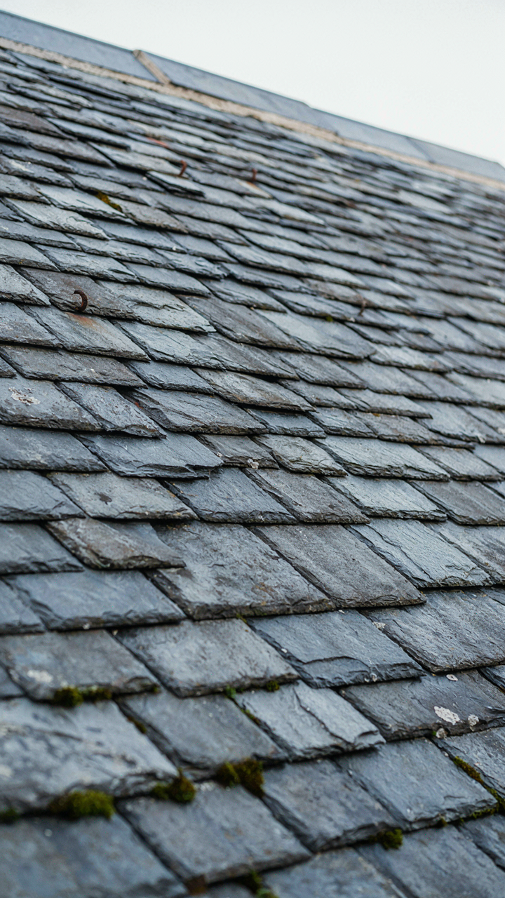 A close-up of an old, durable slate roof on a traditional scottish cottage.