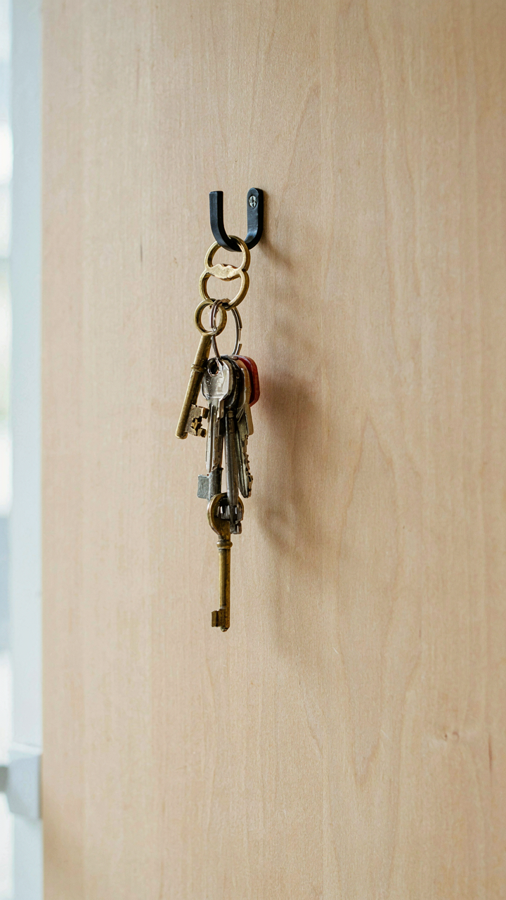 A key chain with separate keys for a cottage and a main house.