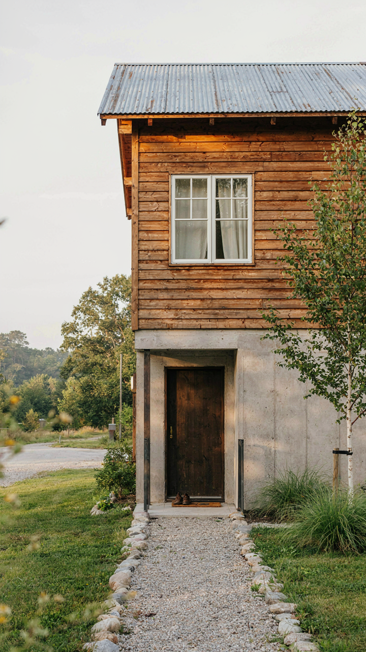 Exterior of a cottage guest house built with durable, natural materials.