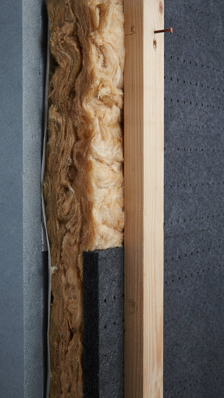 A cutaway view shows insulation and sound panels inside a wall.