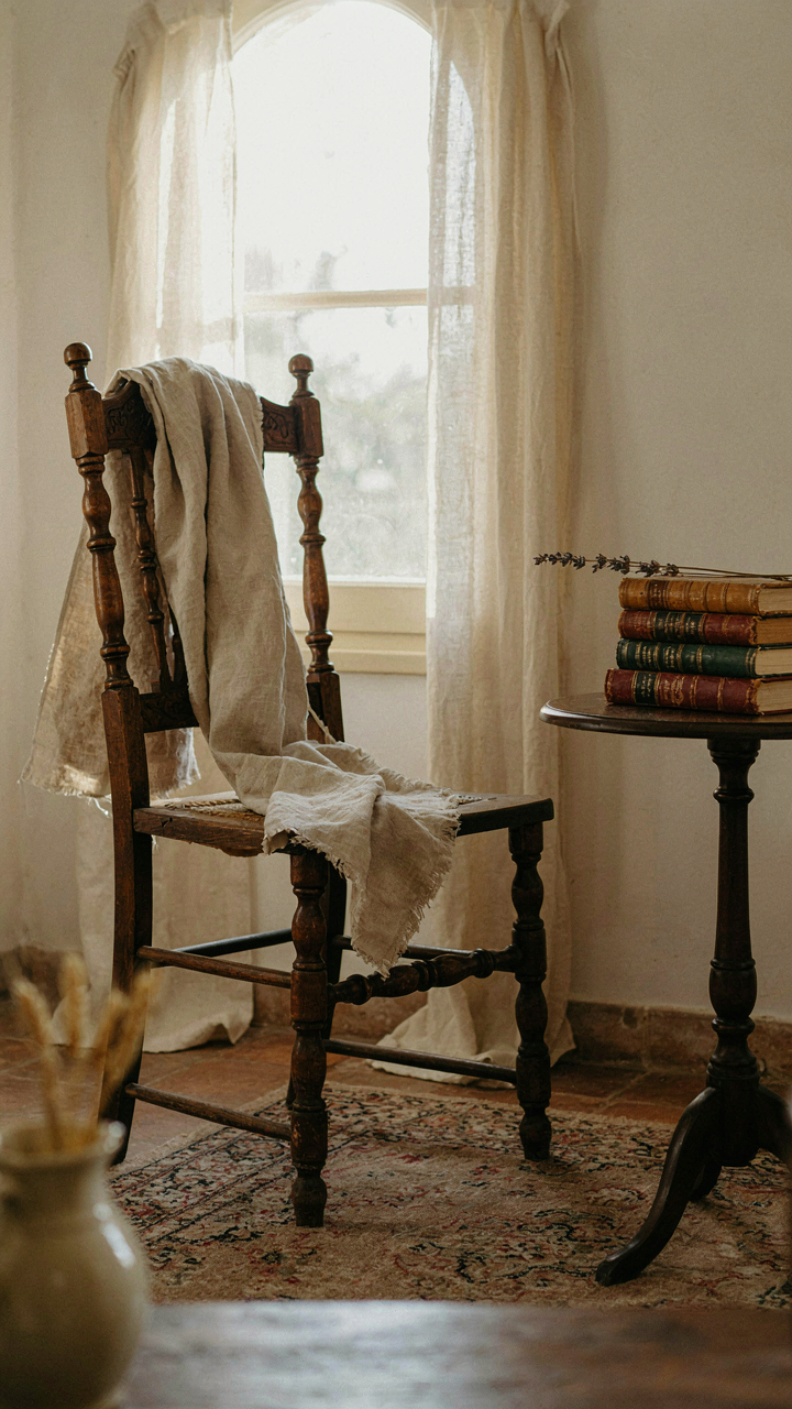 A worn linen cloth casually draped over an antique wooden chair.