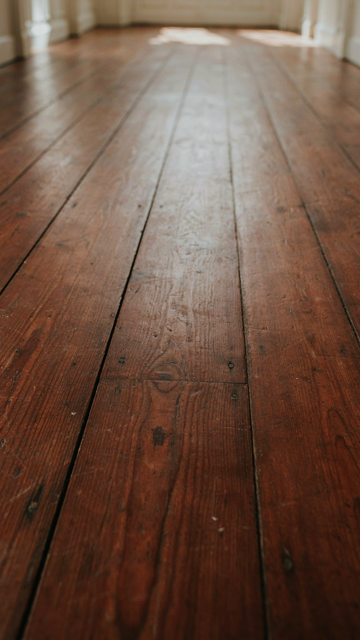 Close-up of a mahogany floor worn smooth after two centuries.