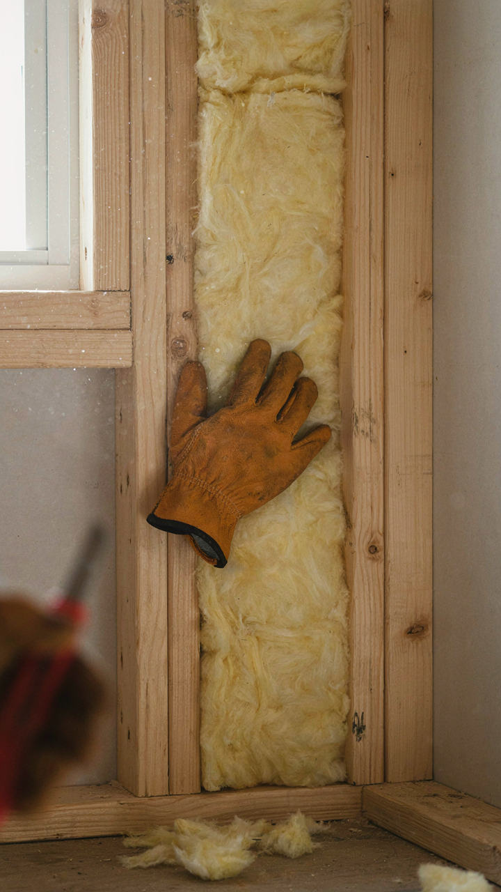 Fiberglass insulation batts installed in a she shed wall.